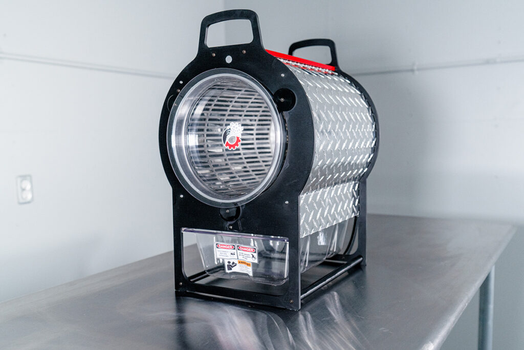 mini dry bud trimmer on stainless steel table.